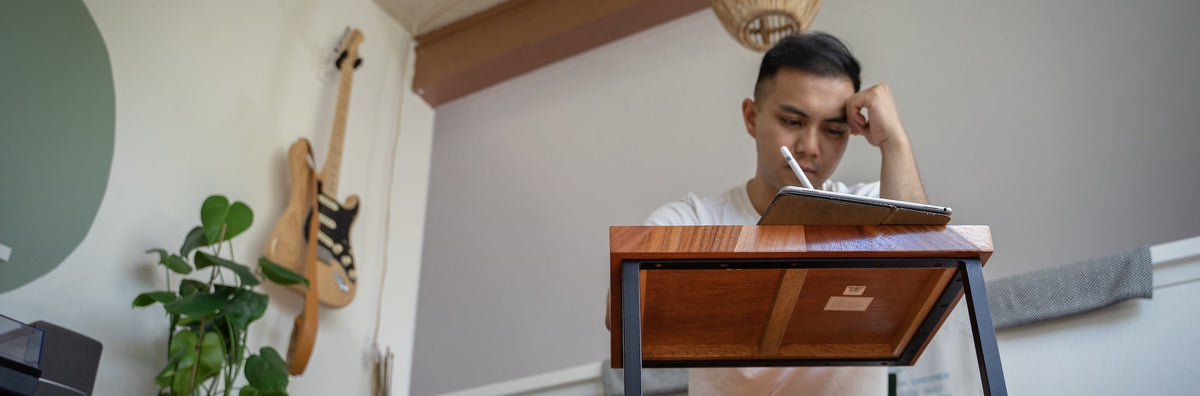 Man working on an Ipad at a desk