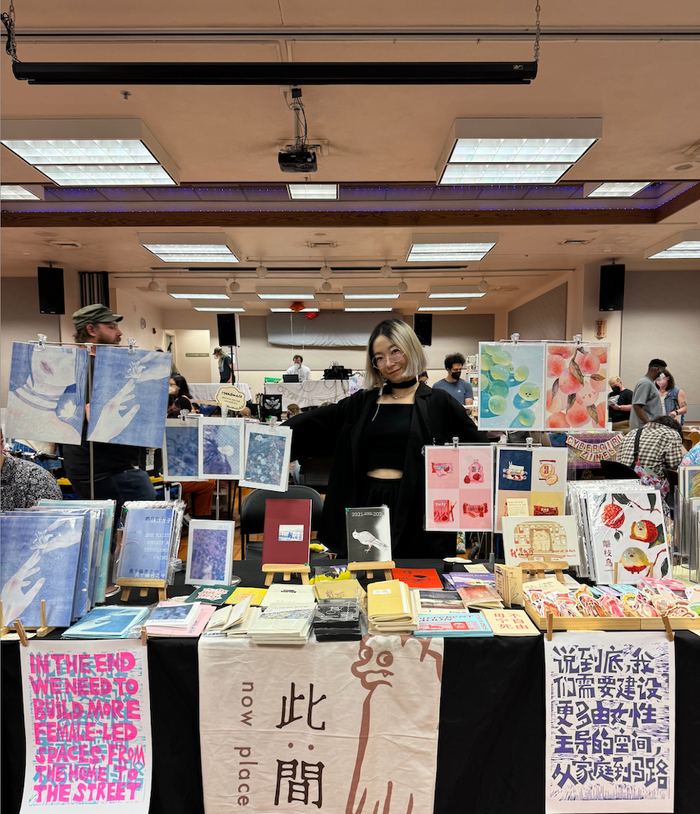 Photo of the artist tabling at an event